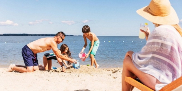 A group of people playing on the beach AI-generated content may be incorrect.